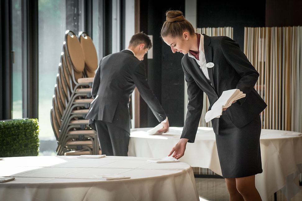 Two EHL students preparing the tables