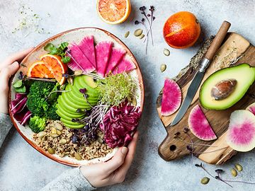 Colourful superfoods on a plate such as avocado, quinoa and olives