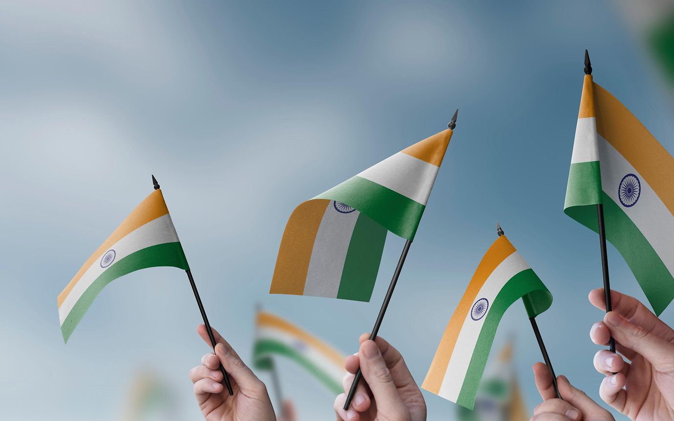 people waving small Indian flags