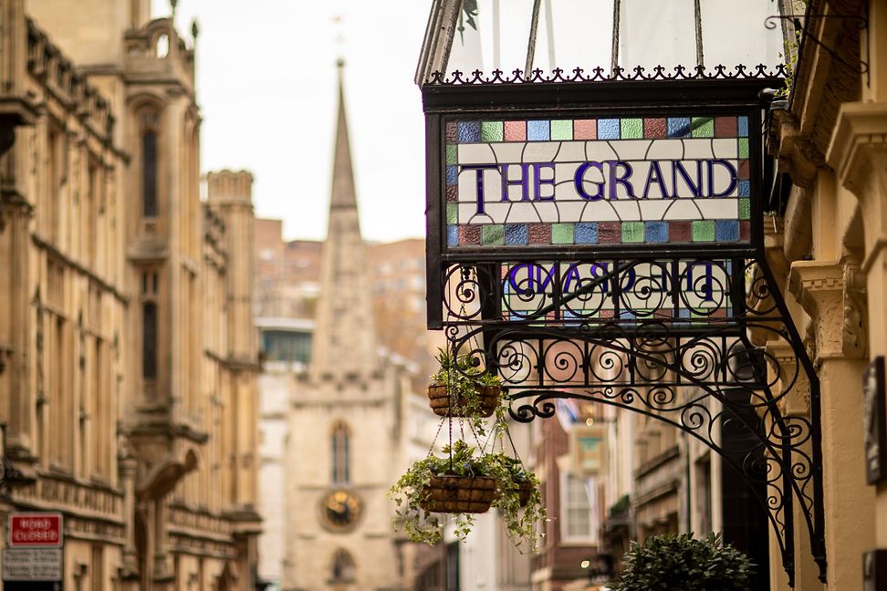 Hotel sign of The Grand in a beautiful street in Bristol with sandstone-coloured facades