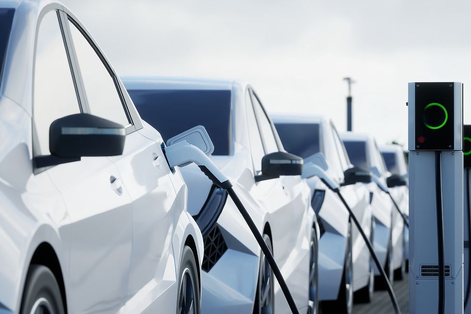 A row of white cars refuelling at a filling station.