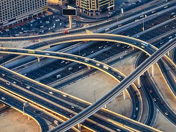 A bird's eye view of a major urban motorway with multiple entrances and exits.