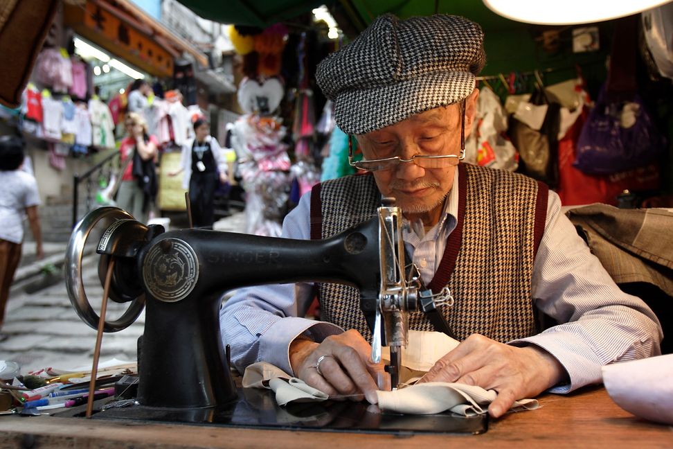 Old man working on a sewing machine