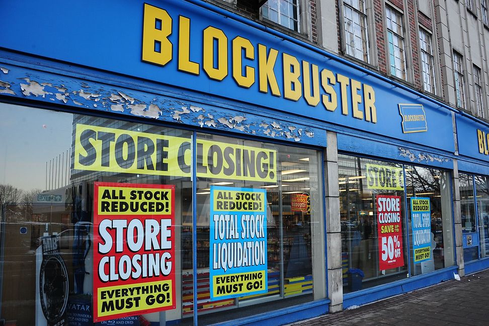 A shop front with large posters announcing an impending closure.