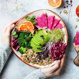 Colourful superfoods on a plate such as avocado, quinoa and olives